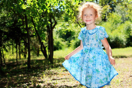 Shot of a cute red-haired girl having a rest outdoor.の写真素材