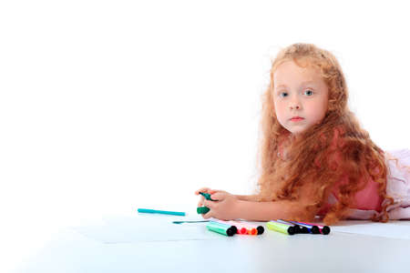 Portrait of a happy girl with felt pens. Isolated over white background.の写真素材