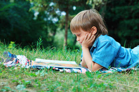 Shot of a little boy having a rest outdoor.の写真素材