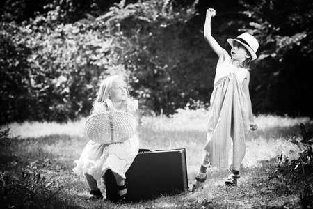 Two beautiful children walking together. Retro style.の写真素材