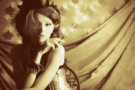 Portrait of a fashionable lady over vintage background.の写真素材