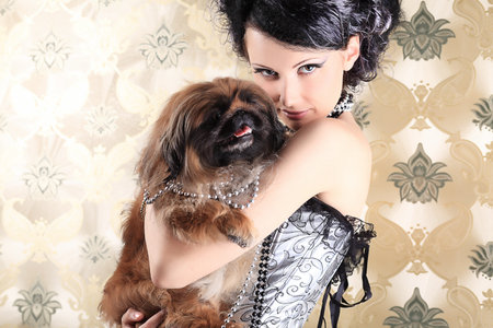 Portrait of a fashionable lady with a dog over vintage background.の写真素材