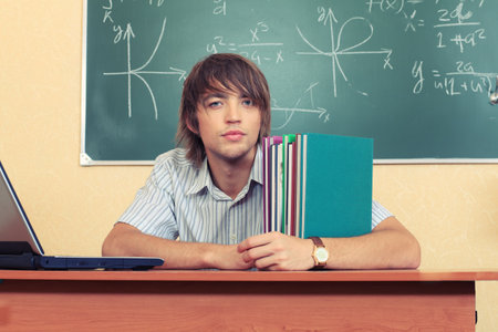 Educational theme: male student in a classroom.