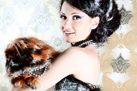 Portrait of a fashionable lady with a dog over vintage background.の写真素材