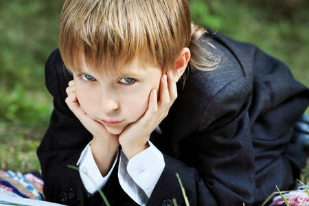 Shot of a little boy having a rest outdoor.の写真素材