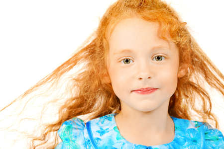 Portrait of a cute red-haired girl. Isolated over white background.の写真素材