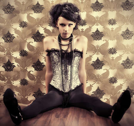 Beautiful fashionable woman over vintage background.の写真素材