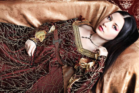 Portrait of a beautiful woman in medieval era dress. Shot in a studio.の写真素材