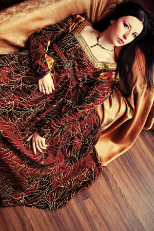 Portrait of a beautiful woman in medieval era dress. Shot in a studio.の写真素材