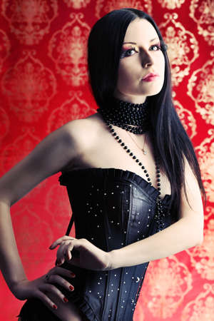 Beautiful sexy woman in black lingerie over vintage background.の写真素材