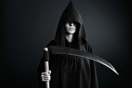 Woman death reaper over black background  Halloween  の写真素材