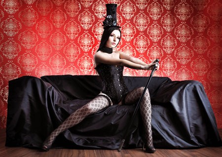 Beautiful sexy woman in black lingerie over vintage background.の写真素材