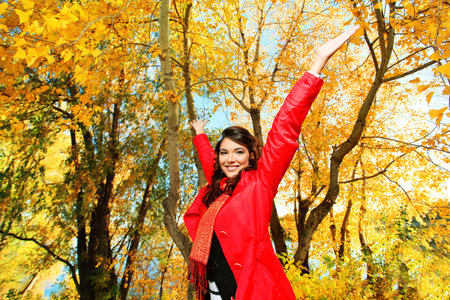 Young pretty woman at the autumn park.