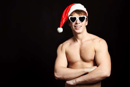 Portrait of a handsome young man in Santa Claus hat. Christmas.の写真素材