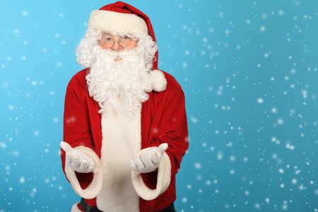 Portrait of Santa Claus over blue background. Christmas.の写真素材