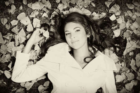 Young pretty woman at the autumn parkの写真素材