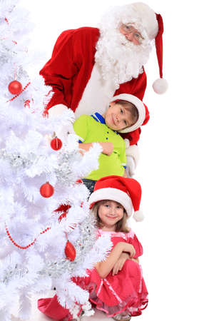 Christmas theme: Santa Claus and children having a fun. Isolated over white background.の写真素材