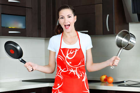 Shouting housewife on a kitchen at home.の写真素材