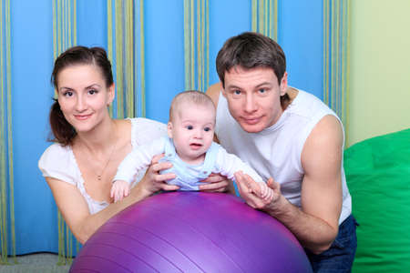 Happy parents with baby at home.の写真素材