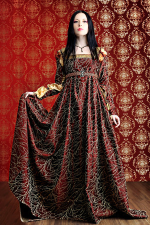 Portrait of a beautiful woman in medieval era dress. Shot in a studio.