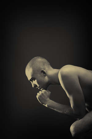 Portrait of a handsome muscular man posing over black background.の写真素材