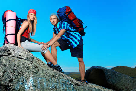 Couple of tourists making their journey at the mountains.の写真素材