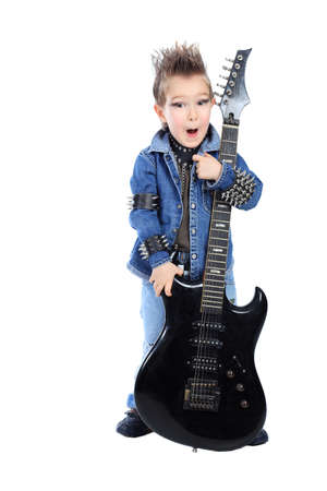 Shot of a little boy playing rock music with electric guitar. Isolated over white background.の写真素材