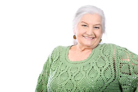 Portrait of a smiling senior woman. Isolated over white background.