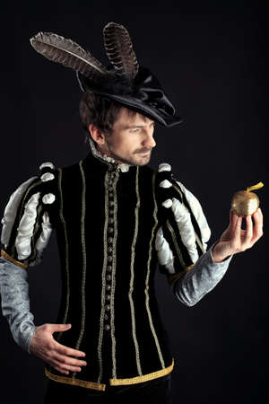 Portrait of a handsome man grandee in 16th century costume. Shot in a studio over black background.の写真素材