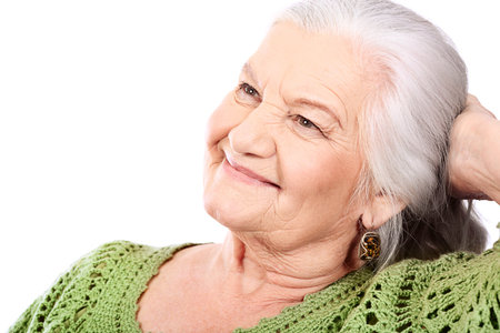 Portrait of a smiling senior woman. Isolated over white background.