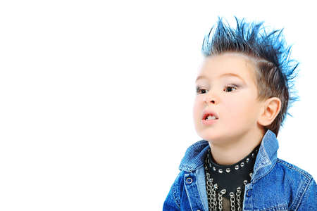 Shot of an emotional little boy wearing rock music clothes. Isolated over white background.の写真素材