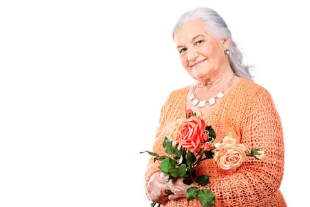 Portrait of a smiling senior woman. Isolated over white background.の写真素材