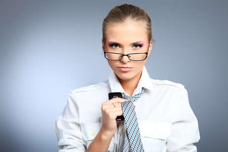 Beautiful businesswoman. Studio shot over grey background.の写真素材