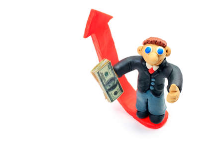 Shot of a plasticine businessman in a suit holding money. Isolated over white background.の写真素材