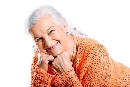 Portrait of a smiling senior woman. Isolated over white background.の写真素材
