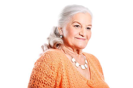 Portrait of a smiling senior woman. Isolated over white background.の写真素材