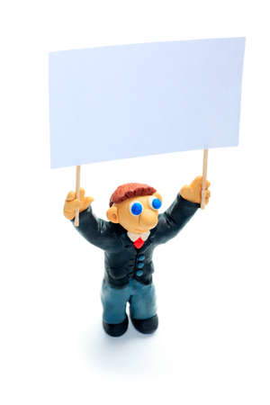 Shot of a plasticine businessman in a suit holding poster. Isolated over white background.の写真素材
