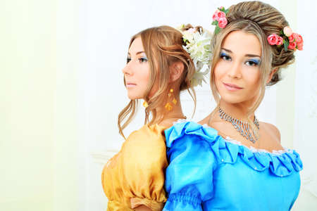 Two beautiful women in medieval era dresses.の写真素材
