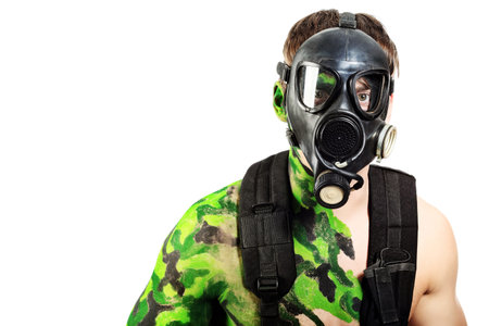 Shot of a conceptual soldier painted in khaki colors in gas mask. Studio shot.の写真素材
