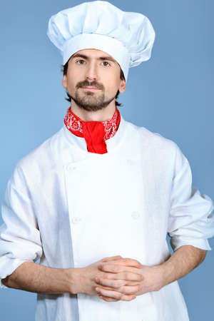 Portrait of a man cook. Shot in a studio over grey background.の写真素材