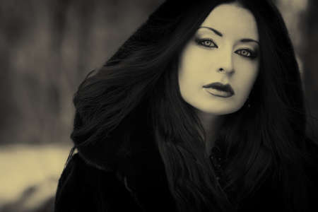 Shot of a gothic woman in a winter park. Fashion.の写真素材