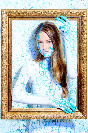 Art project: beautiful woman painted with many vivid colors. 