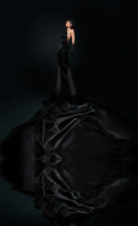 Beautiful fashionable woman in black dress. Studio shot.の写真素材