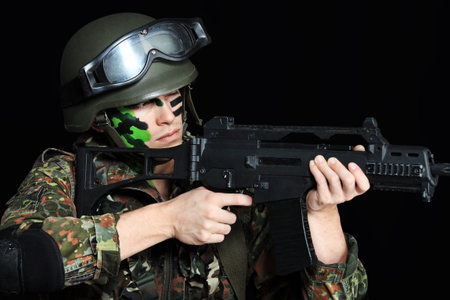 Shot of a conceptual soldier painted in khaki colors. Over black background.