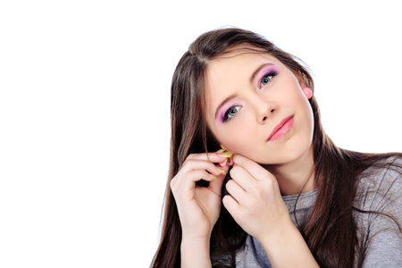 Portrait of a girl teenager. Isolated over white background.の写真素材