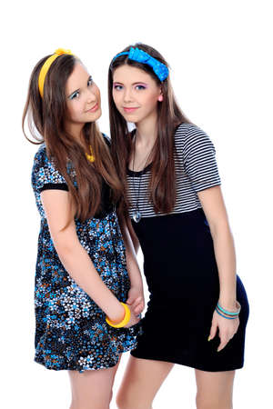 Two happy girls friends. Isolated over white background.の写真素材