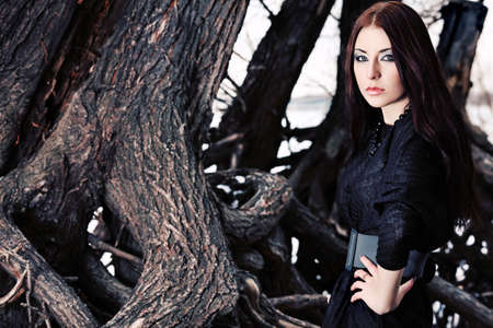 Shot of a gothic woman in a winter park. Fashion.の写真素材