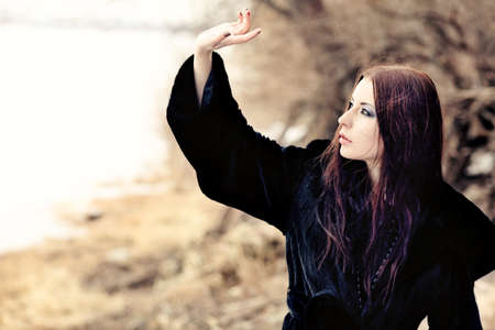 Shot of a gothic woman in a winter park. Fashion.の写真素材