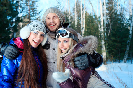 Group of young people having winter rest outdoor.
