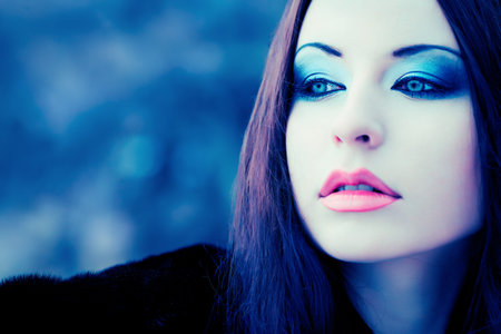 Shot of a gothic woman in a winter park. Fashion.の写真素材